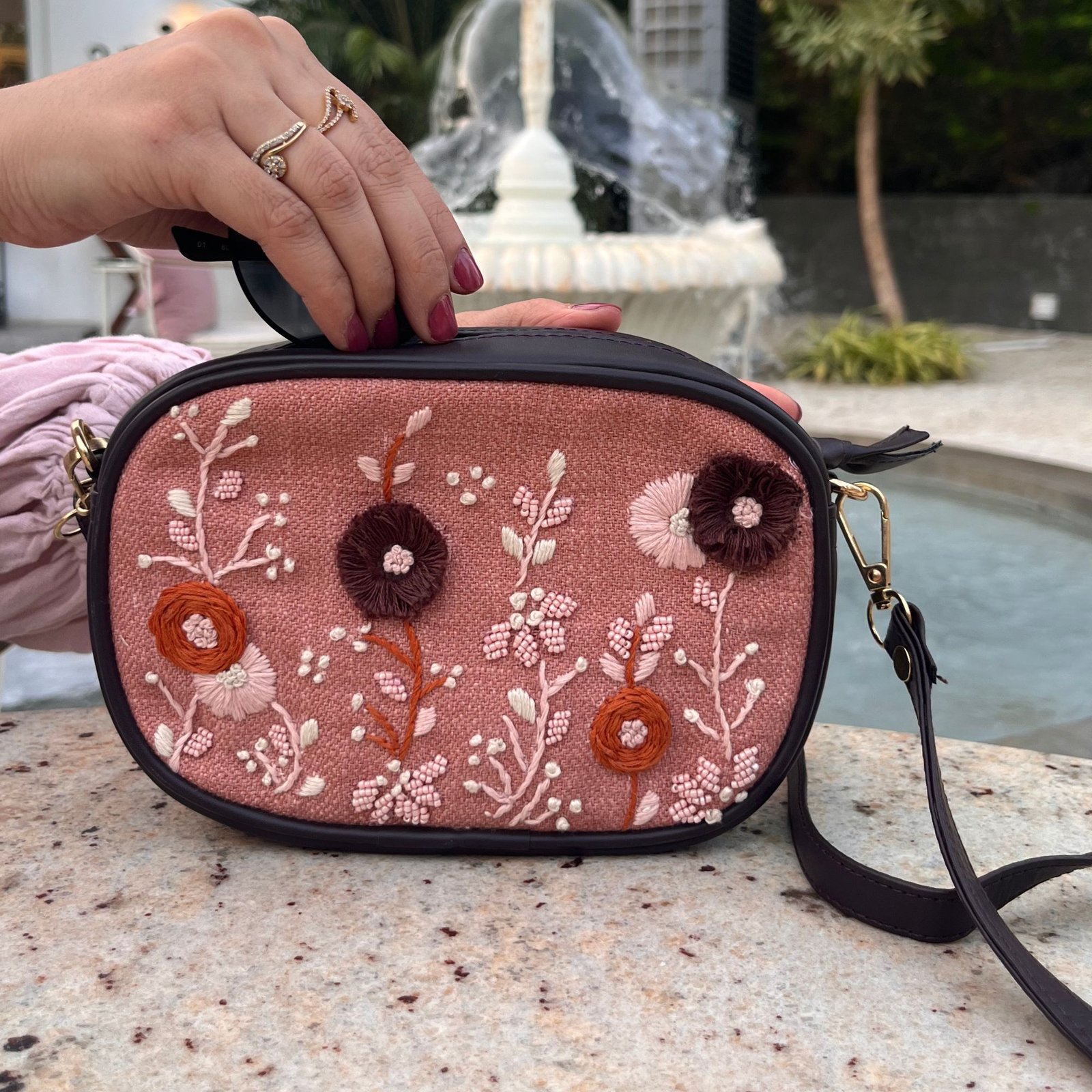 Close-up of embroidered Wild Birdie fanny bag with zip closure
