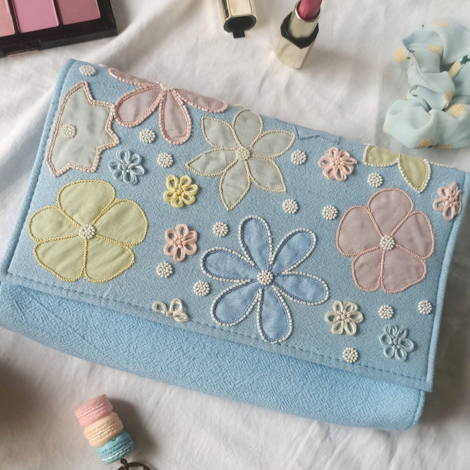 Embroidered pastel envelope bag close-up detailing Embroidered pastel envelope bag close-up detailing