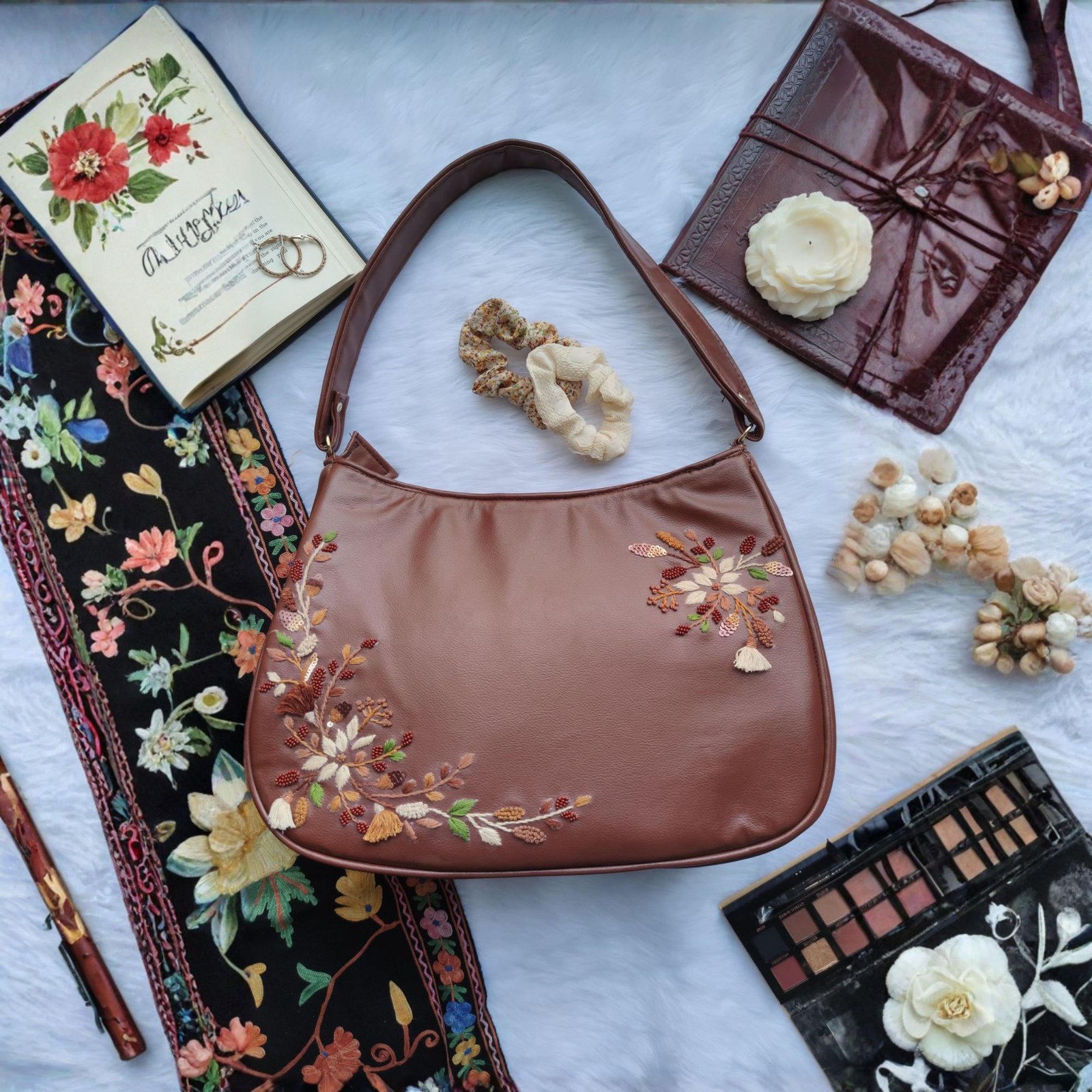 Tan hobo bag displayed in flat lay showing soft curved design Tan hobo bag displayed in flat lay showing soft curved design
