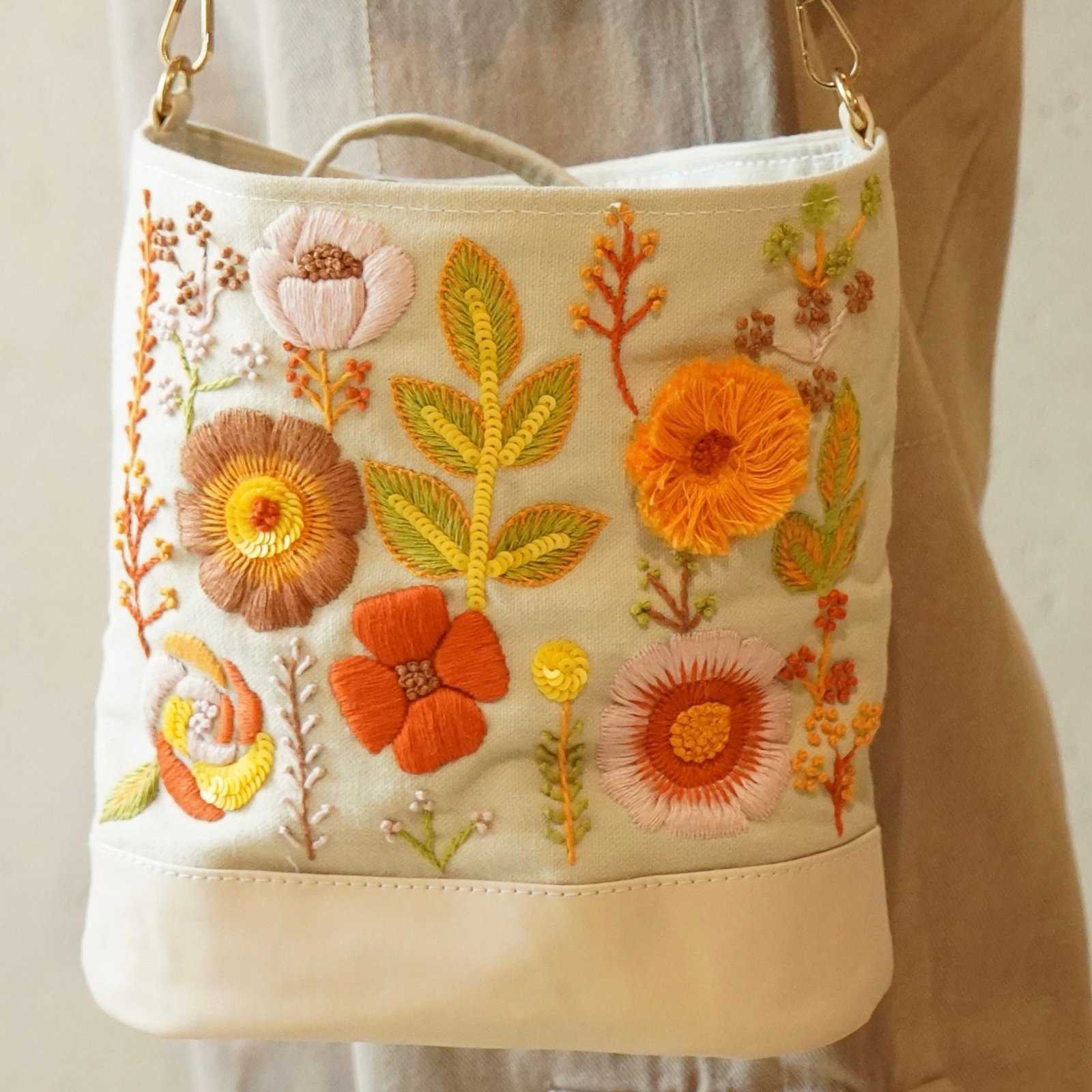 amber bloom bucket bag beige floral embroidered front view