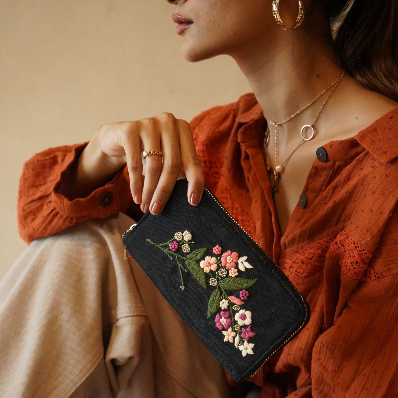 black mini bloom companion floral embroidered pouch lifestyle close-up